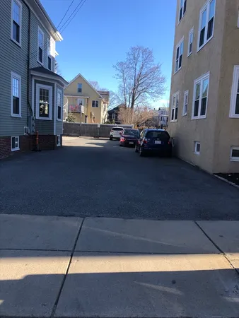 a view of building with cars parked