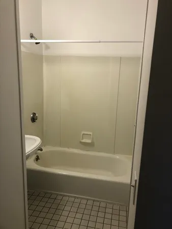 a bathroom with a shower and a bathtub