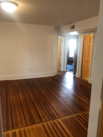 a view of wooden floor and windows in a room