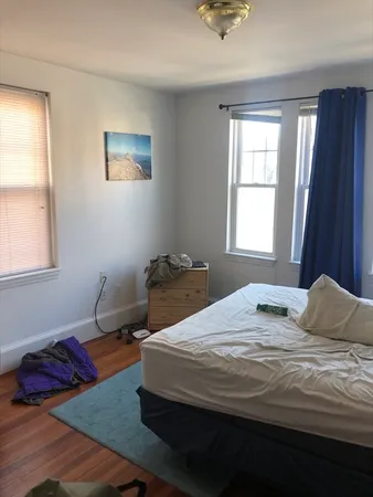a bedroom with a bed and window