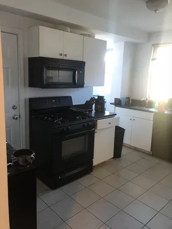 a kitchen with a stove and a microwave