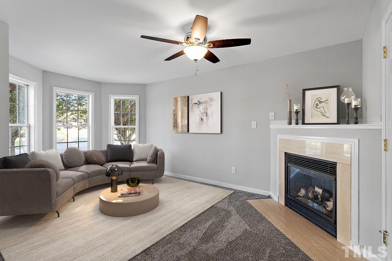 4840 Windblown Court Raleigh, NC 27616 - Photo 3 of 30 a living room with furniture and a fireplace