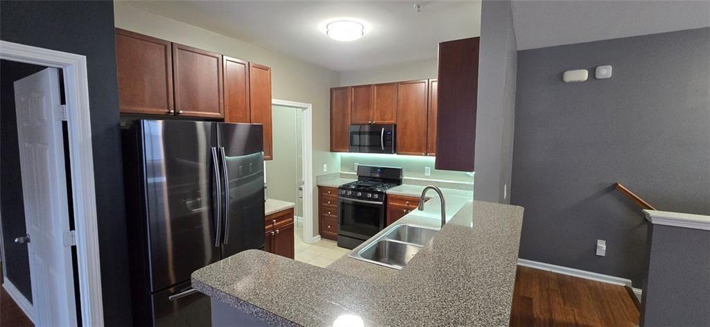 3500 Sweetwater Road, Unit 225 Duluth, GA 30096 - Photo 17 of 34 a kitchen with stainless steel appliances granite countertop a refrigerator and a stove