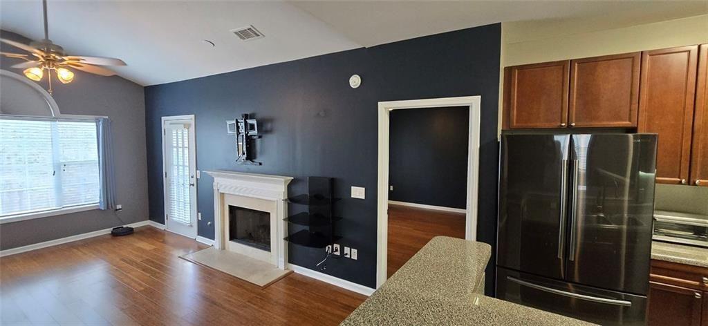 3500 Sweetwater Road, Unit 225 Duluth, GA 30096 - Photo 20 of 34 a living room with furniture wooden floor and a fireplace