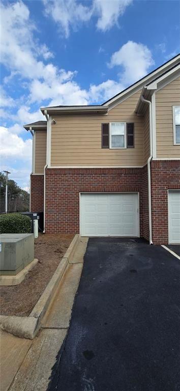 3500 Sweetwater Road, Unit 225 Duluth, GA 30096 - Photo 2 of 34 a front view of a house with a yard and garage