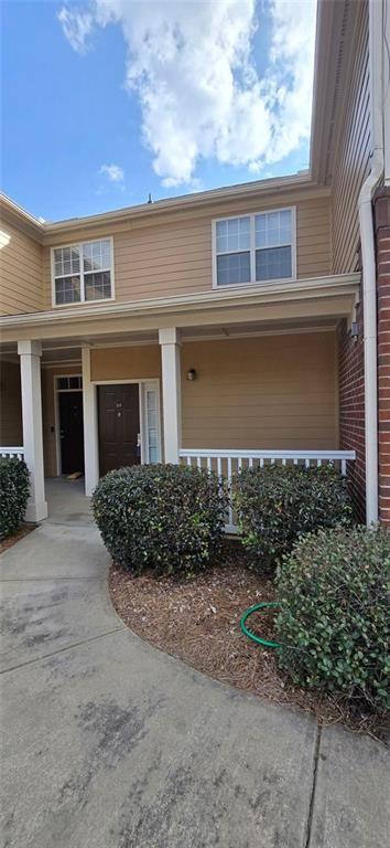 3500 Sweetwater Road, Unit 225 Duluth, GA 30096 - Photo 5 of 34 a front view of a house with a yard and garage