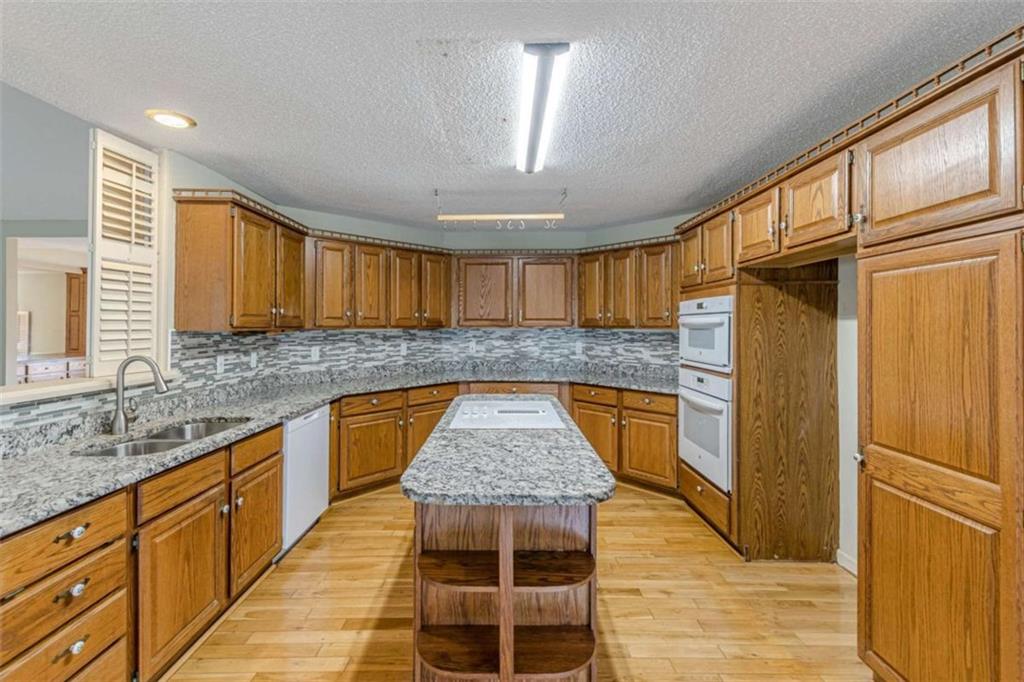 1380 Elliott Road McDonough, GA 30252 - Photo 13 of 33 a kitchen with granite countertop stainless steel appliances a counter space and a window
