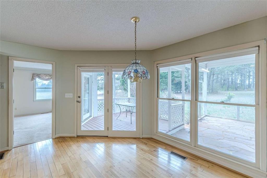 1380 Elliott Road McDonough, GA 30252 - Photo 14 of 33 a view of an empty room with window and wooden floor