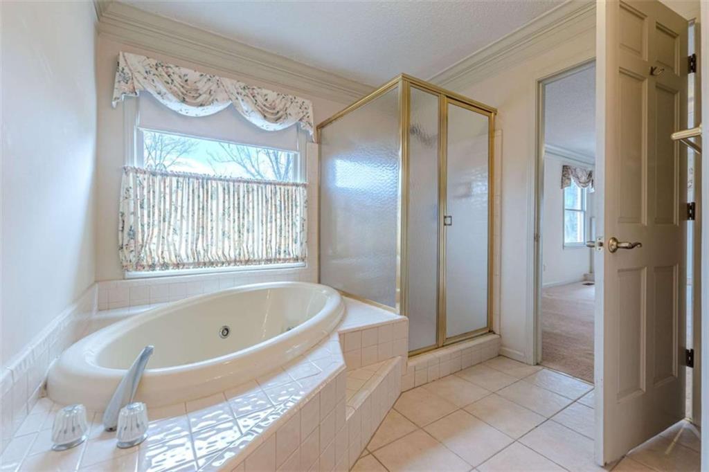 1380 Elliott Road McDonough, GA 30252 - Photo 18 of 33 a bathroom with a bathtub and a shower