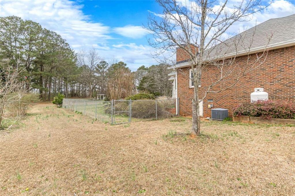 1380 Elliott Road McDonough, GA 30252 - Photo 24 of 33 a backyard of a house with lots of green space