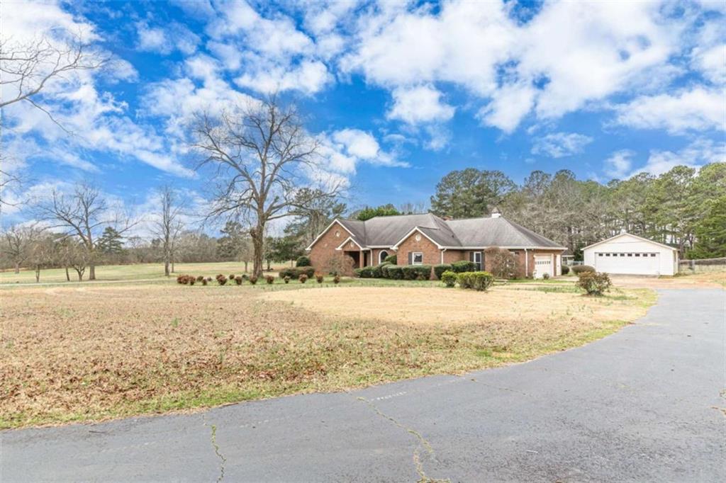 1380 Elliott Road McDonough, GA 30252 - Photo 3 of 33 a view of a large house with a big yard and large trees