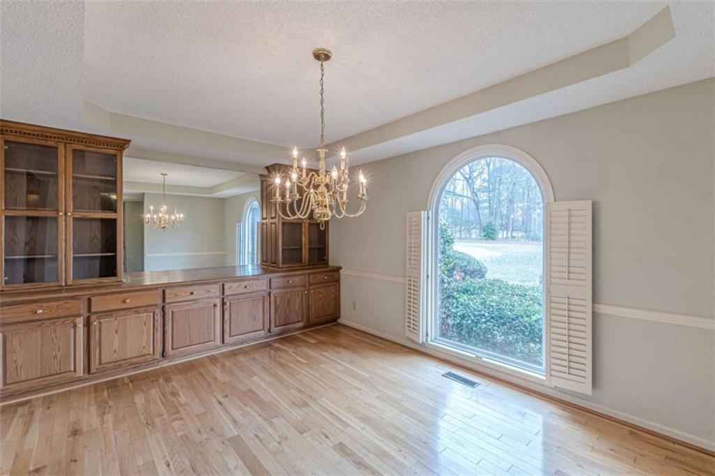 1380 Elliott Road McDonough, GA 30252 - Photo 8 of 33 a view of a room with wooden floors and chandelier