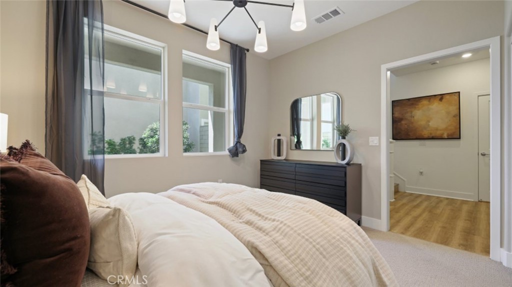 300 Junco Irvine, CA 92618 - Photo 16 of 34 a bedroom with a bed and a mirror on the dresser