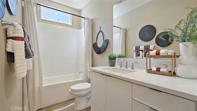 a bathroom with a granite countertop sink mirror toilet and vanity