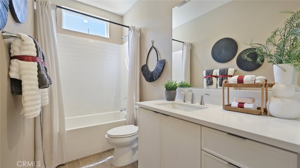 300 Junco Irvine, CA 92618 - Photo 17 of 34 a bathroom with a granite countertop sink mirror toilet and vanity