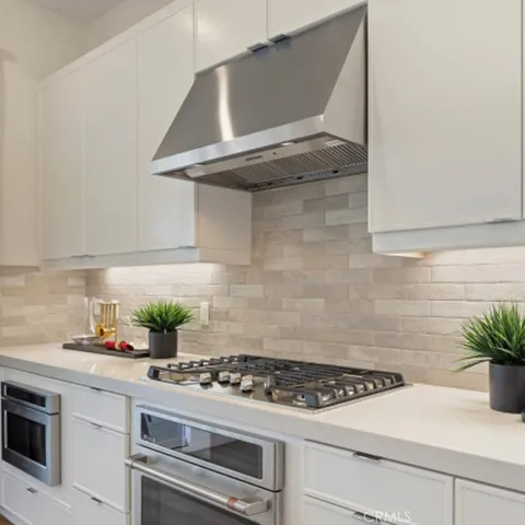 a kitchen with a stove and cabinets