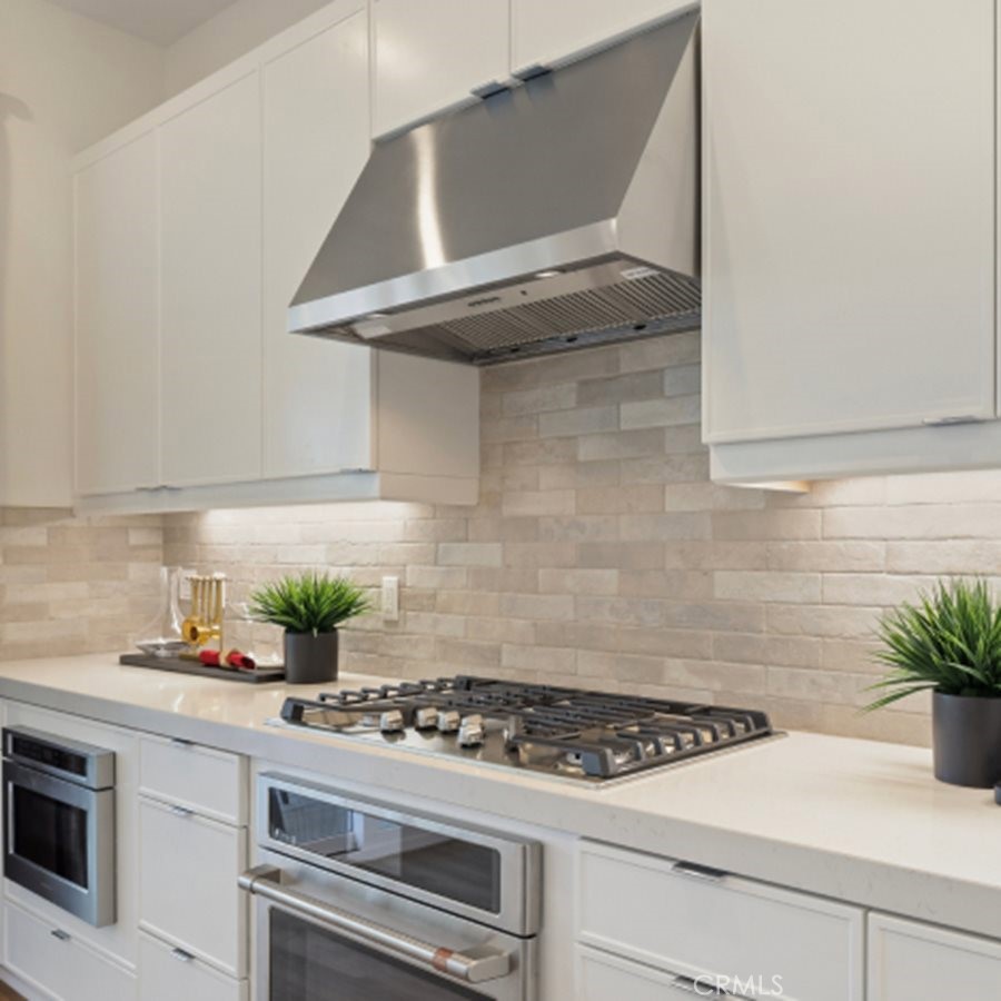 300 Junco Irvine, CA 92618 - Photo 5 of 34 a kitchen with a stove and cabinets