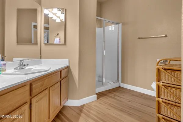 a bathroom with a double vanity sink mirror and shower