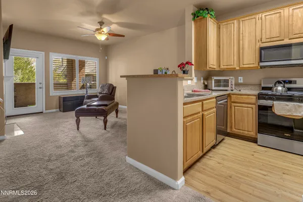 a kitchen with granite countertop a sink stainless steel appliances and cabinets