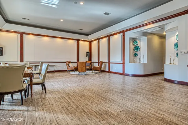 an empty room with large windows and table