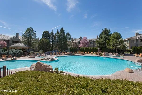 a view of a swimming pool with lounge chair