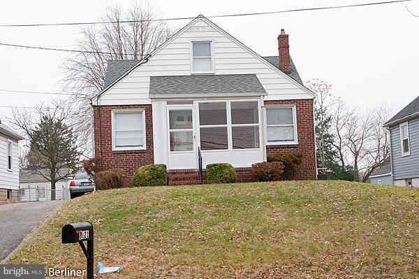 8121 Old Philadelphia Road Baltimore, MD 21237 - Photo 2 of 22 a front view of a house with a yard