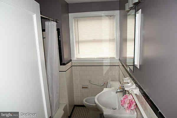 8121 Old Philadelphia Road Baltimore, MD 21237 - Photo 11 of 22 a bathroom with a sink toilet and shower