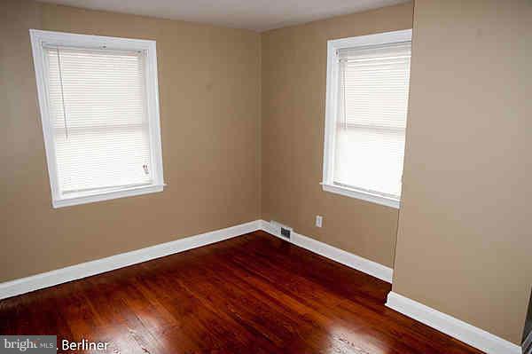 8121 Old Philadelphia Road Baltimore, MD 21237 - Photo 14 of 22 an empty room with wooden floor and a window