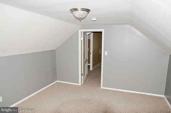 8121 Old Philadelphia Road Baltimore, MD 21237 - Photo 17 of 22 a view of a hallway with a chandelier fan