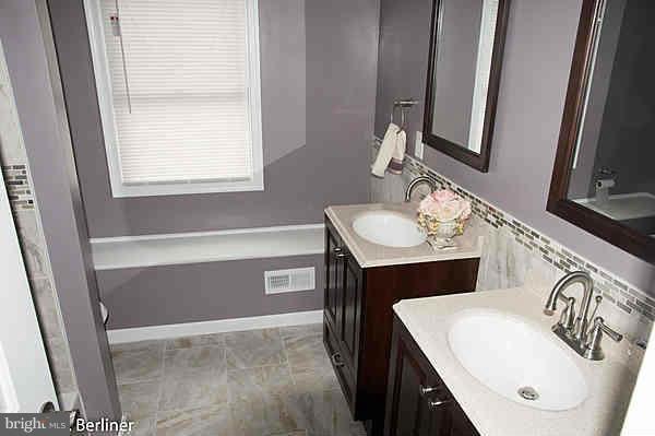 8121 Old Philadelphia Road Baltimore, MD 21237 - Photo 18 of 22 a bathroom with a sink and a mirror