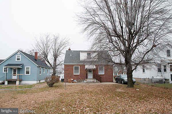 8121 Old Philadelphia Road Baltimore, MD 21237 - Photo 5 of 22 a front view of a house with a yard