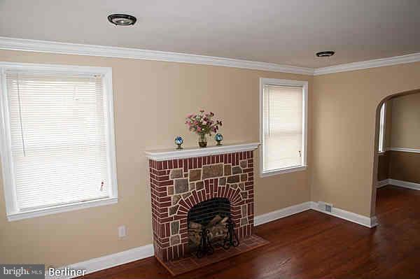 8121 Old Philadelphia Road Baltimore, MD 21237 - Photo 6 of 22 a view of an empty room with wooden floor and a window