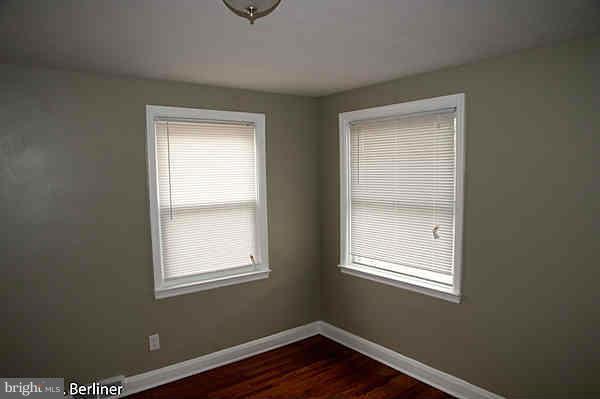 8121 Old Philadelphia Road Baltimore, MD 21237 - Photo 10 of 22 a view of an empty room with wooden floor and a window