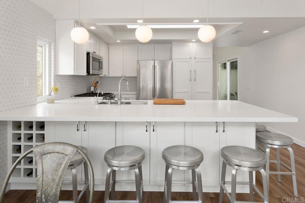 1736 Hill Top Lane Encinitas, CA 92024 - Photo 11 of 41 a kitchen with stainless steel appliances a sink and a refrigerator