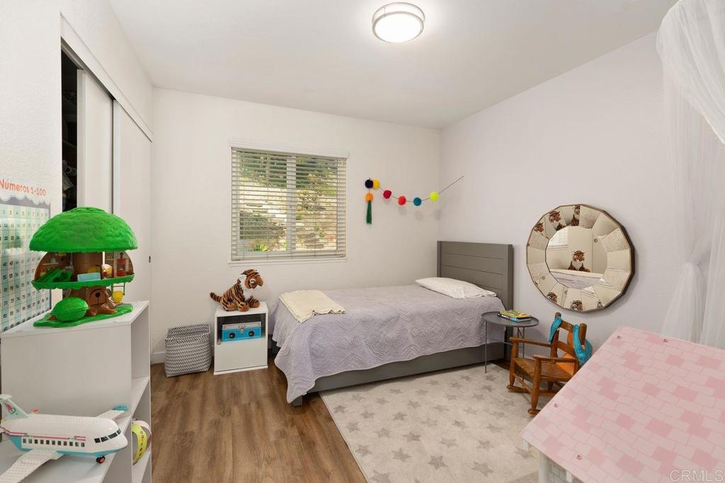 1736 Hill Top Lane Encinitas, CA 92024 - Photo 30 of 41 a bedroom with bed and a chandelier