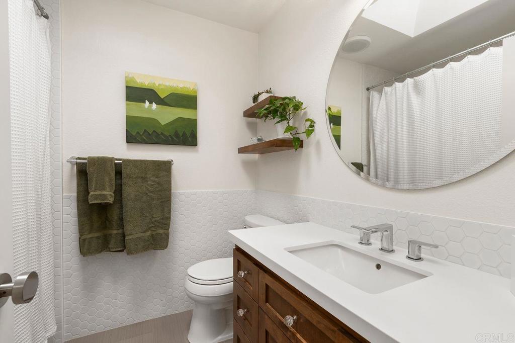 1736 Hill Top Lane Encinitas, CA 92024 - Photo 31 of 41 a bathroom with a sink toilet and mirror
