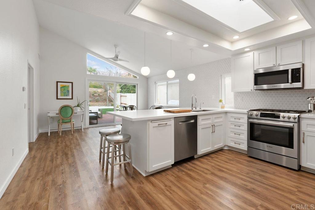 1736 Hill Top Lane Encinitas, CA 92024 - Photo 9 of 41 a kitchen with a sink wooden floor and stainless steel appliances