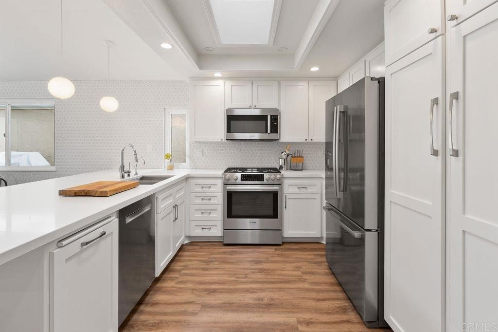 1736 Hill Top Lane Encinitas, CA 92024 - Photo 10 of 41 a kitchen with stainless steel appliances a refrigerator sink and microwave
