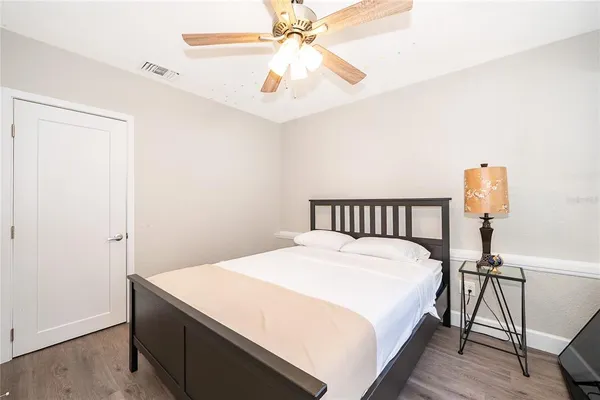 a bedroom with a bed and a chandelier
