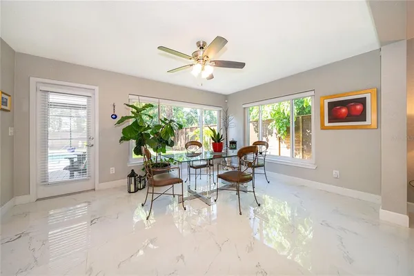 a dining room with furniture and a large window