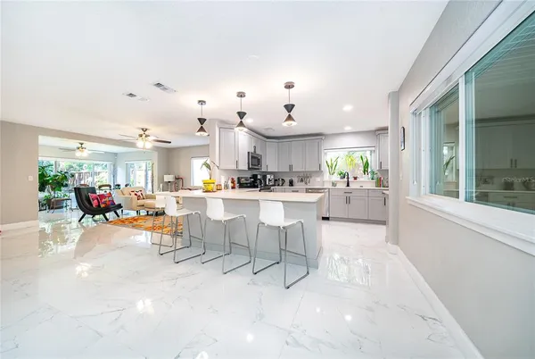 a view of a dining area with furniture and a kitchen