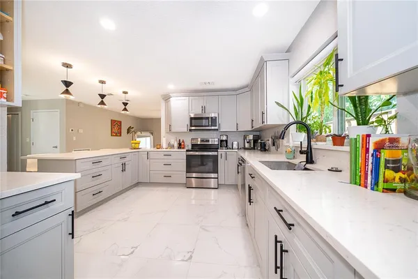 a kitchen with appliances cabinets and a counter top space