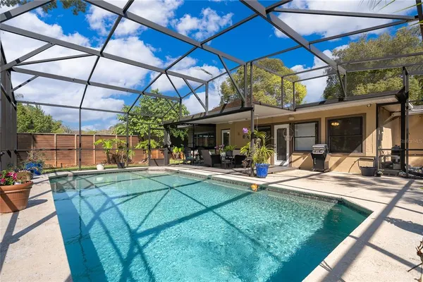 a view of a backyard with dining space and a patio
