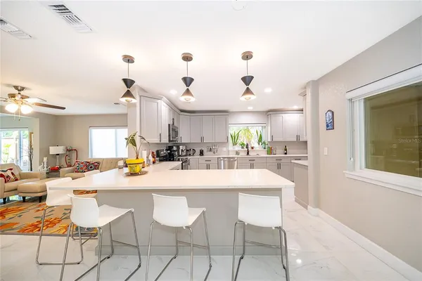 a large kitchen with a table and chairs