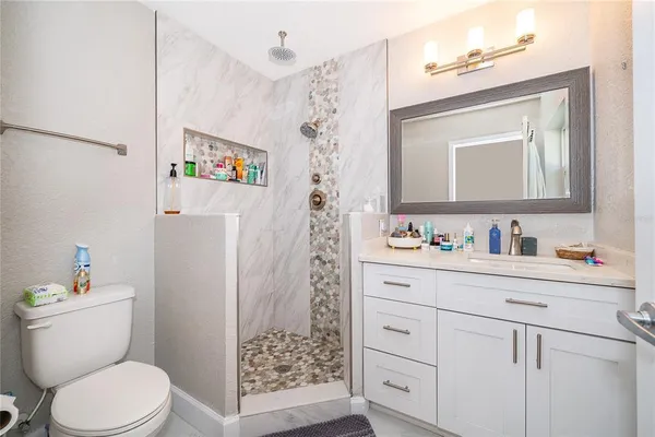 a bathroom with a toilet sink and a mirror