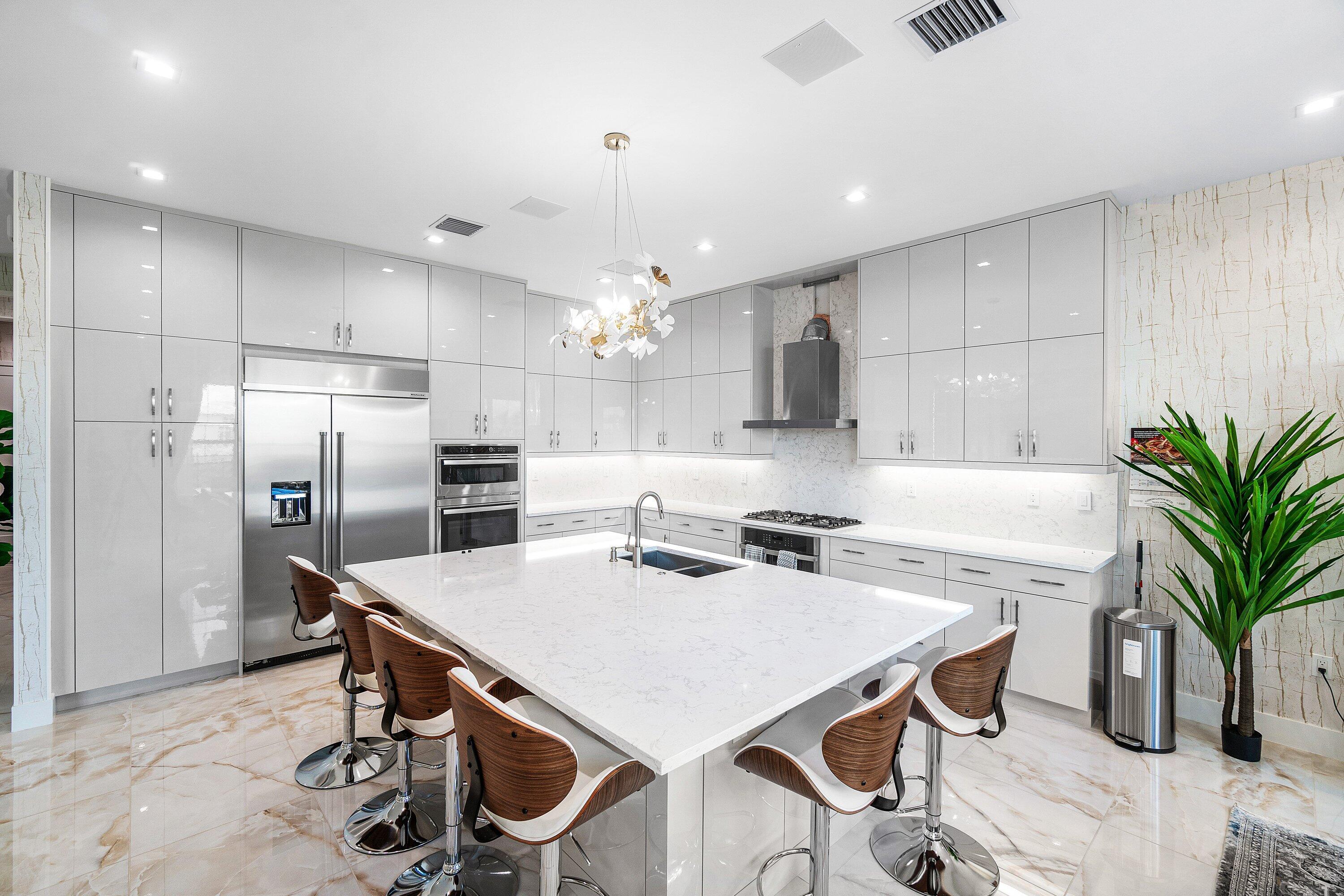 8233 Crystal Downs Avenue Boca Raton, FL 33434 - Photo 14 of 58 a kitchen with a table chairs refrigerator and microwave