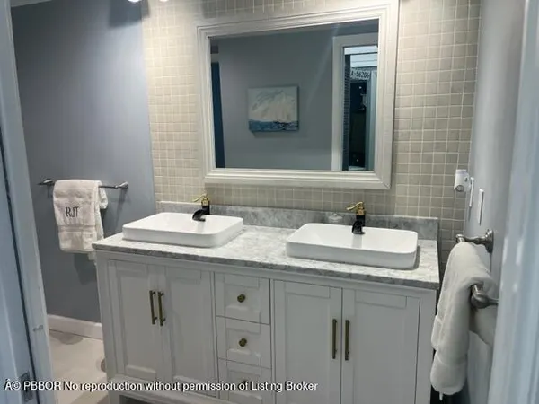 a bathroom with a sink toilet and mirror