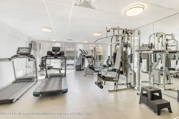 a room with gym equipment and a view of living room