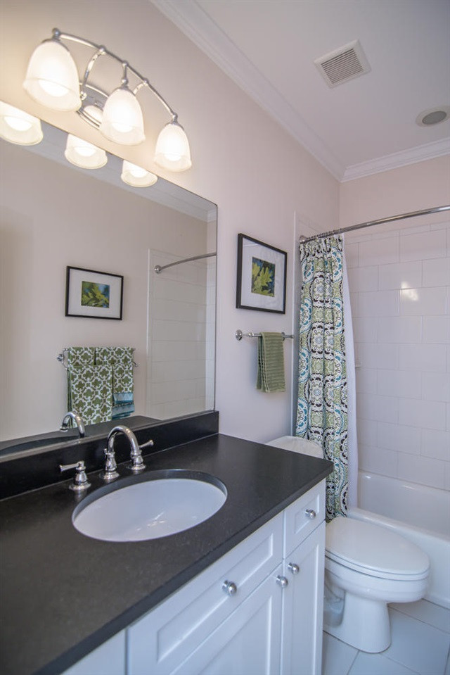 3310 Westover Road Durham, NC 27707 - Photo 20 of 30 a bathroom with a granite countertop sink a toilet and a mirror