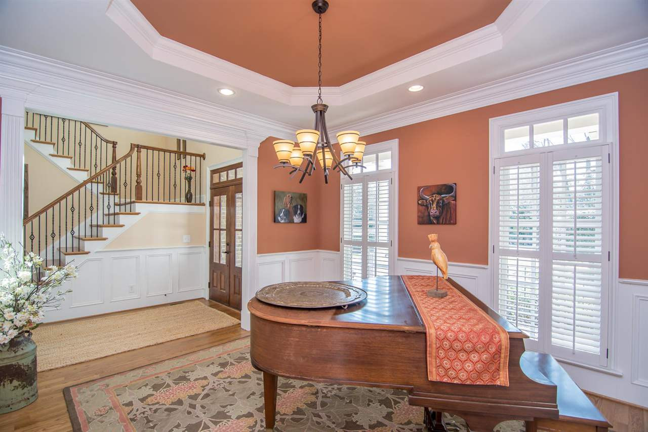 3310 Westover Road Durham, NC 27707 - Photo 3 of 30 a living room with furniture and a chandelier